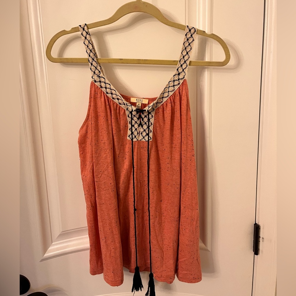 Kori razor back tank. Cute burnt orange with white and black straps.